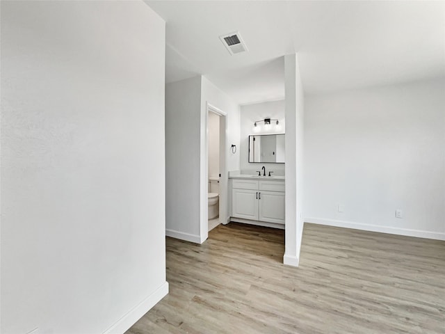 hall featuring sink and light hardwood / wood-style flooring