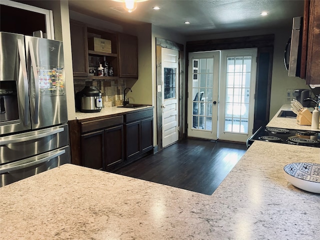 kitchen featuring appliances with stainless steel finishes, dark hardwood / wood-style flooring, sink, and dark brown cabinetry