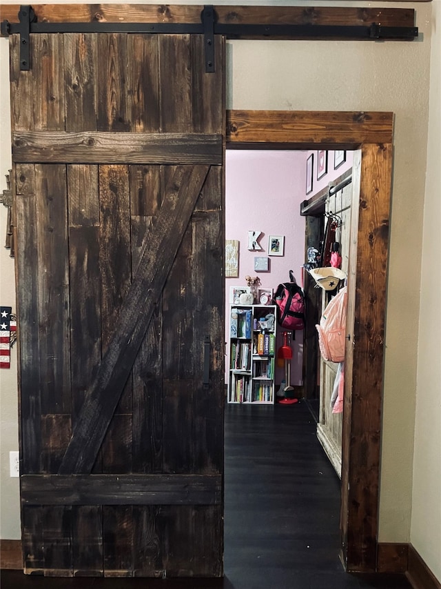 interior space featuring hardwood / wood-style flooring and a barn door