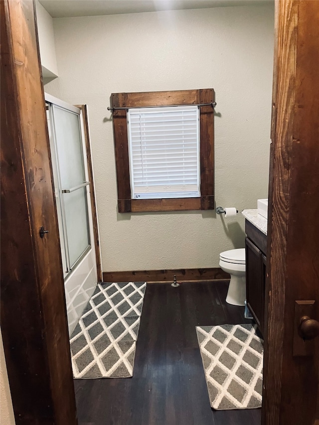 bathroom featuring vanity, toilet, and hardwood / wood-style floors