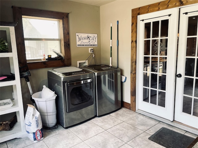 laundry room featuring light tile patterned flooring and separate washer and dryer