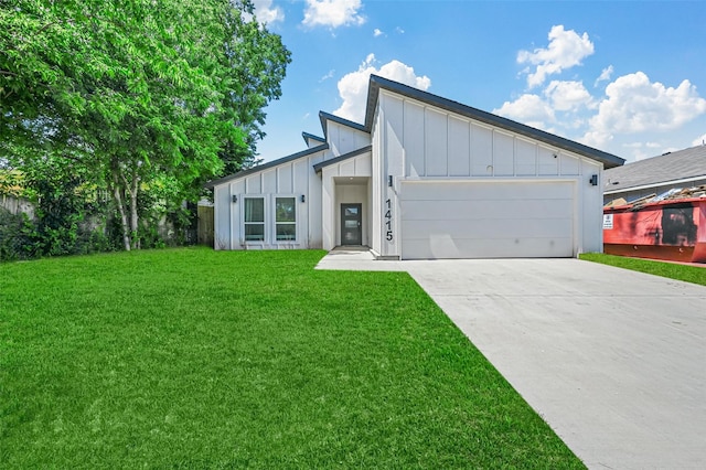 view of front of property with a garage and a front lawn