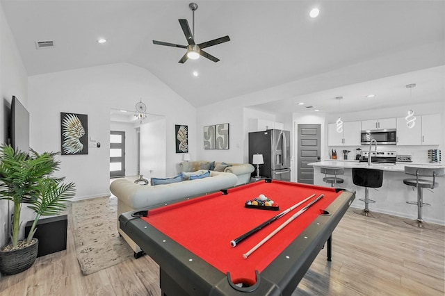 rec room with vaulted ceiling, ceiling fan, light hardwood / wood-style floors, and billiards