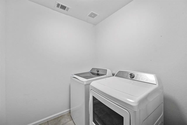 washroom with light tile patterned floors and independent washer and dryer