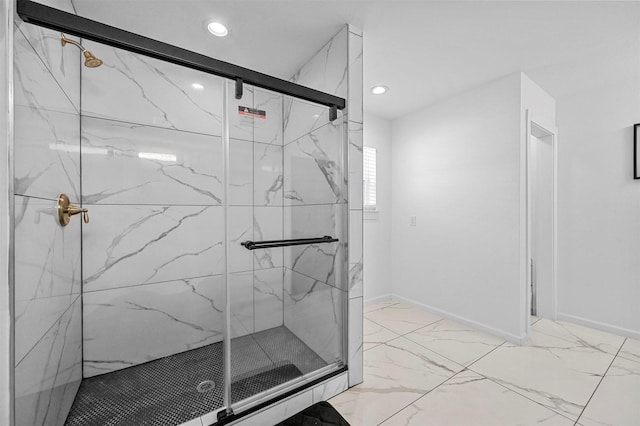 bathroom featuring a shower with door