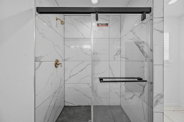 bathroom featuring a shower with door