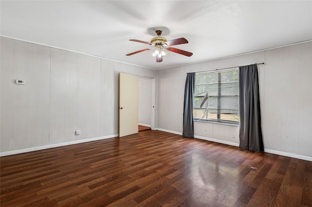 spare room with dark hardwood / wood-style floors and ceiling fan