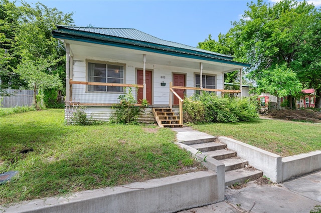 view of front of property with a porch and a front lawn