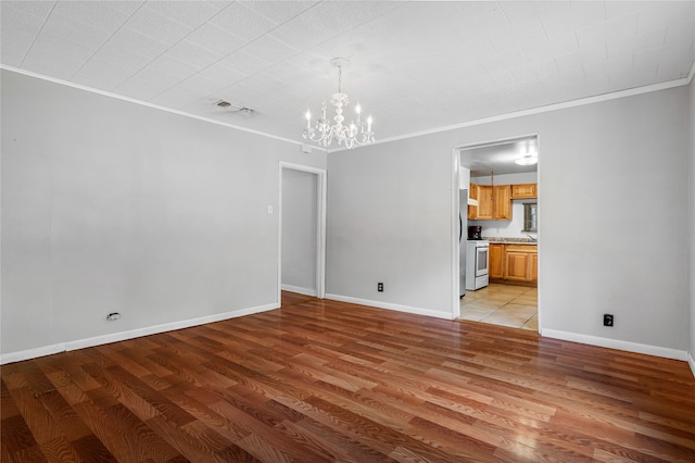 interior space featuring light hardwood / wood-style floors, crown molding, and a chandelier