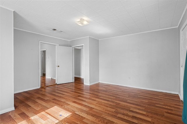 unfurnished bedroom featuring hardwood / wood-style flooring and ornamental molding