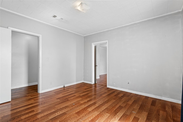 unfurnished room with dark wood-type flooring