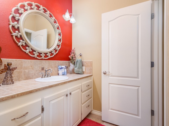 bathroom featuring decorative backsplash, tile patterned floors, and vanity