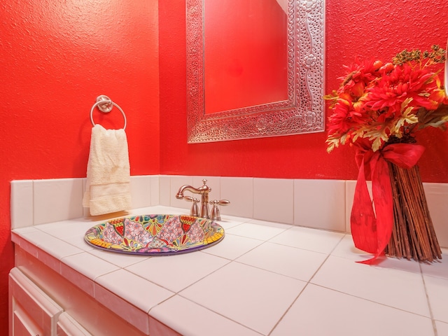 bathroom with sink and tile patterned flooring