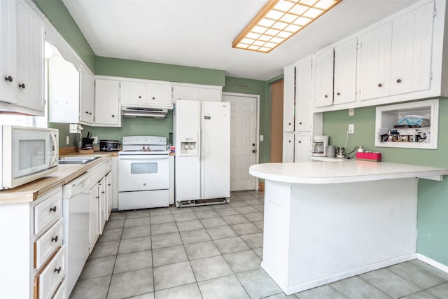 kitchen featuring white appliances, white cabinets, kitchen peninsula, fume extractor, and light tile floors