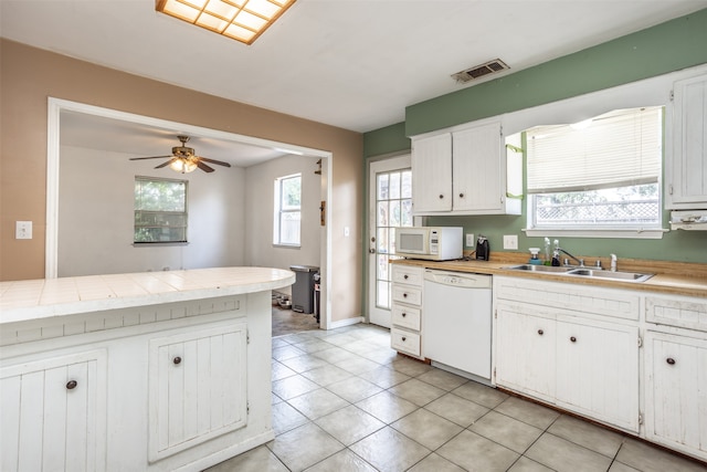 kitchen featuring ceiling fan, white appliances, light tile floors, sink, and white cabinetry