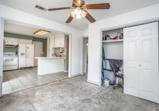 kitchen with light tile flooring, kitchen peninsula, ceiling fan, white appliances, and range hood