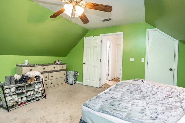 carpeted bedroom featuring lofted ceiling and ceiling fan