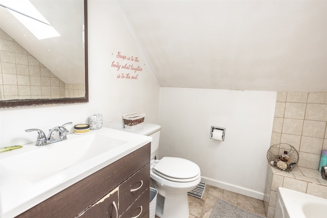 bathroom with toilet, tile flooring, tile walls, and vaulted ceiling with skylight