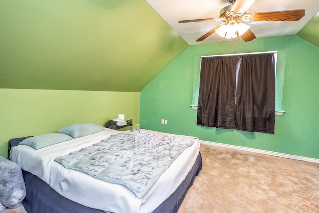 carpeted bedroom featuring ceiling fan and vaulted ceiling