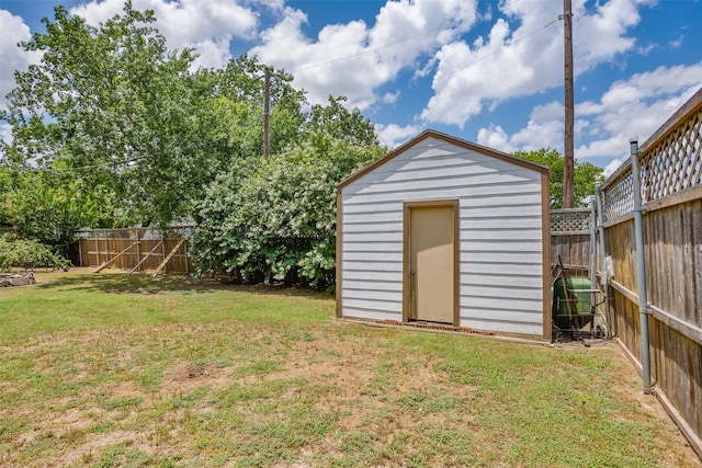 view of outdoor structure featuring a lawn