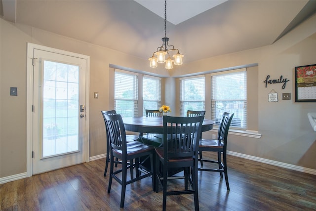 dining room featuring dark wood-type flooring, vaulted ceiling, baseboards, and an inviting chandelier