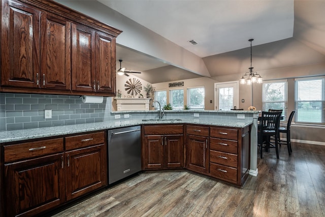 kitchen with a sink, visible vents, vaulted ceiling, and stainless steel dishwasher