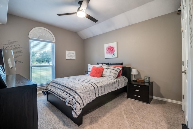 bedroom featuring a ceiling fan, carpet, vaulted ceiling, and baseboards