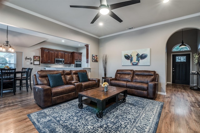 living room with crown molding, hardwood / wood-style floors, and ceiling fan