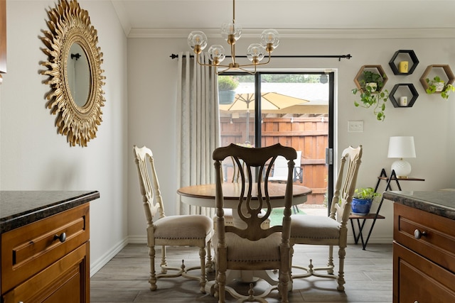 dining room featuring ornamental molding, hardwood / wood-style flooring, and a notable chandelier