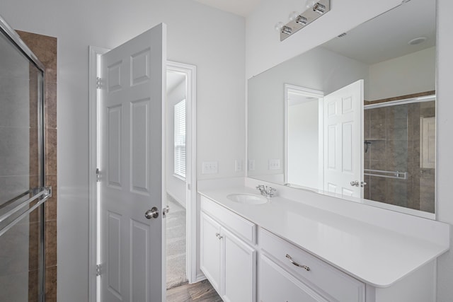 bathroom with vanity, hardwood / wood-style flooring, and walk in shower