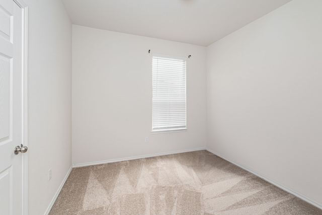 carpeted spare room featuring a wealth of natural light