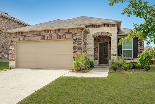 view of front of house with a garage and a front lawn