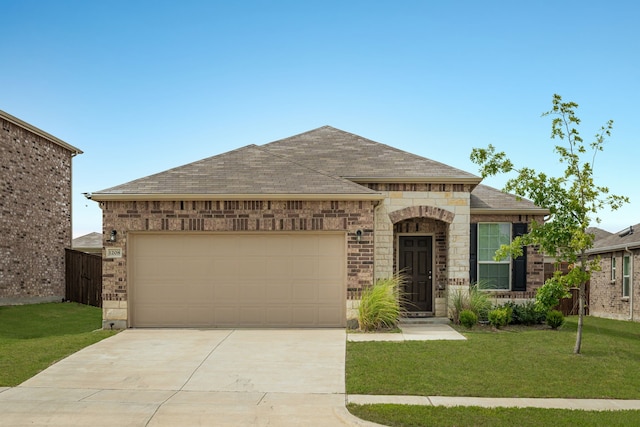 view of front of home featuring a garage and a front lawn