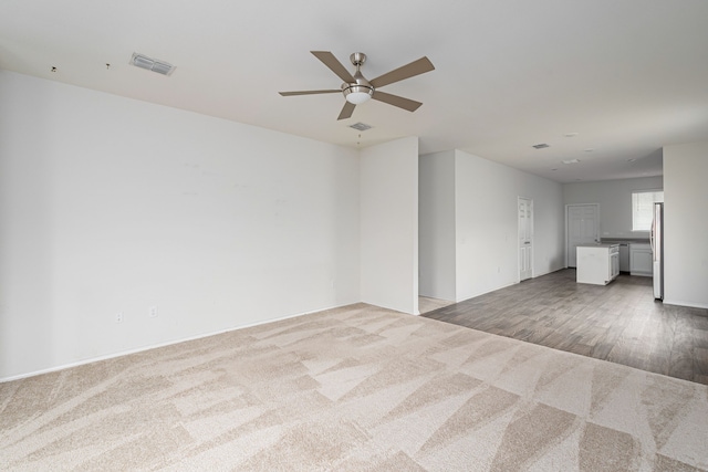 unfurnished room featuring ceiling fan and light wood-type flooring