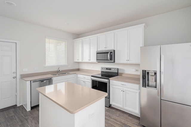 kitchen featuring appliances with stainless steel finishes, white cabinetry, and a center island