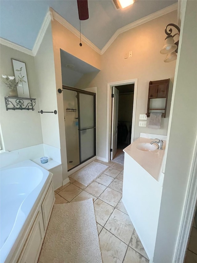 full bathroom featuring crown molding, a garden tub, vaulted ceiling, and vanity