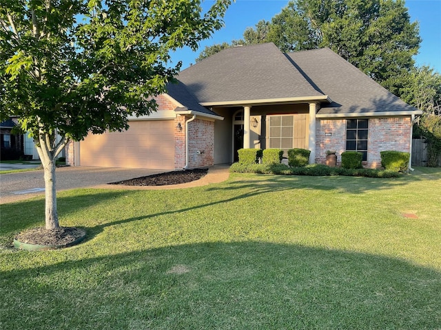 single story home with a garage, brick siding, a shingled roof, and a front lawn