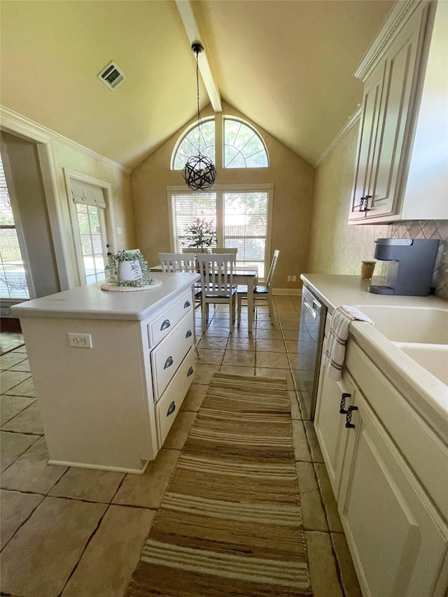 kitchen featuring visible vents, light countertops, stainless steel dishwasher, and a center island