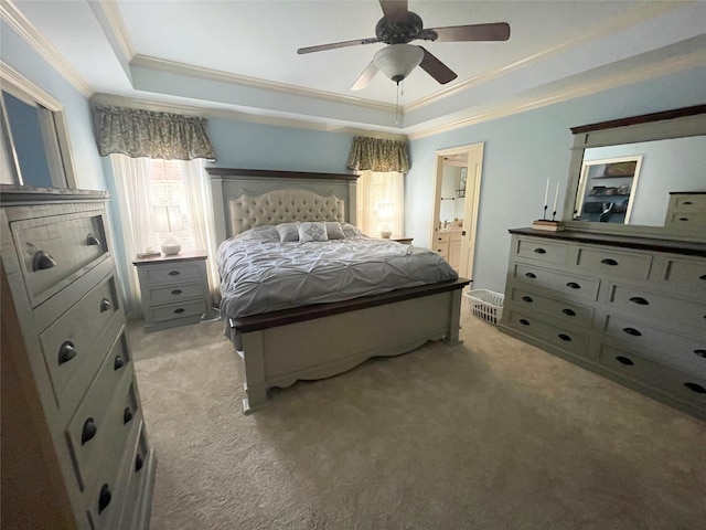 bedroom with ornamental molding, a raised ceiling, light colored carpet, and ceiling fan