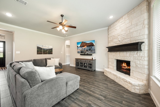 living room with a fireplace, dark wood-type flooring, ceiling fan, and ornamental molding