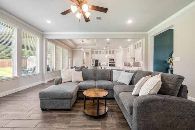 living room with ceiling fan and crown molding