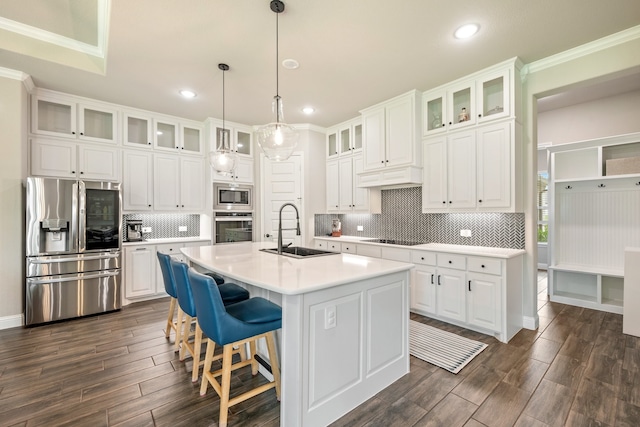 kitchen with white cabinetry, sink, an island with sink, and stainless steel appliances