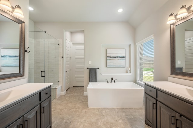 bathroom featuring separate shower and tub, vanity, and lofted ceiling