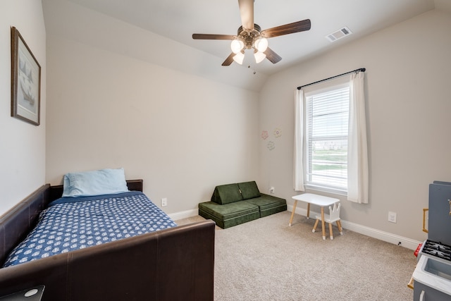 bedroom with ceiling fan, lofted ceiling, and carpet floors