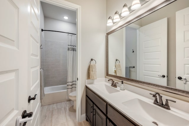 full bathroom featuring shower / bath combo, vanity, and toilet