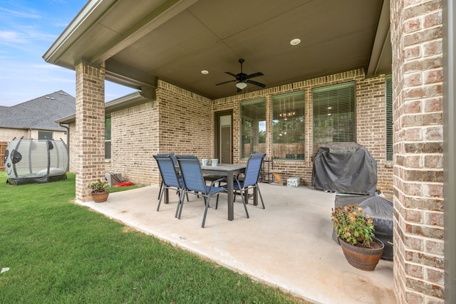 view of patio with a trampoline, grilling area, and ceiling fan