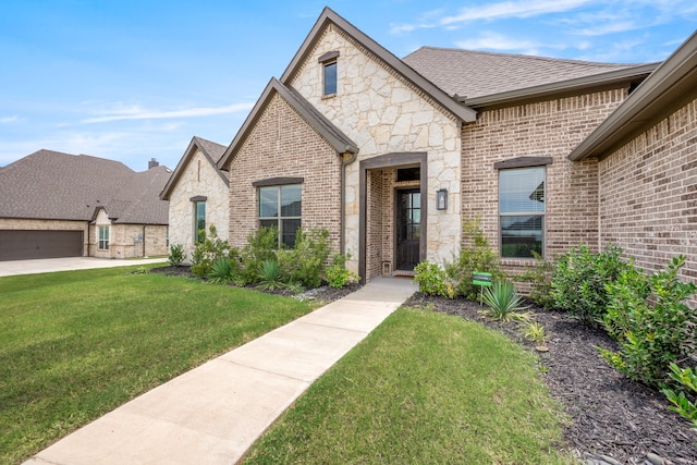 view of front of property with a garage and a front lawn