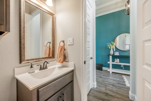 bathroom featuring a chandelier, wood-type flooring, and vanity