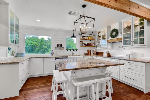 kitchen featuring white cabinetry, sink, dark hardwood / wood-style floors, and a kitchen island