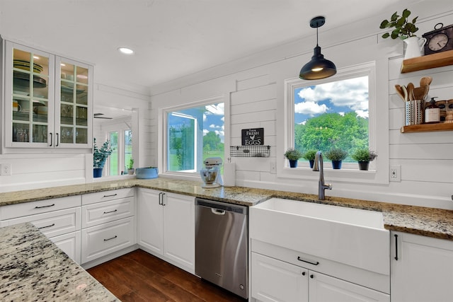 kitchen featuring dishwasher, dark wood-type flooring, hanging light fixtures, and a wealth of natural light